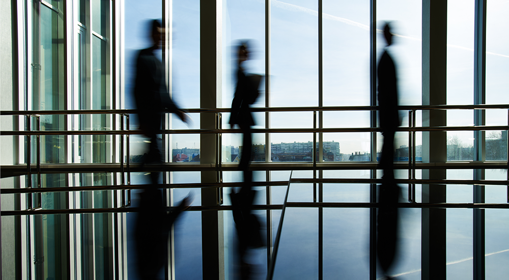 people walking through building